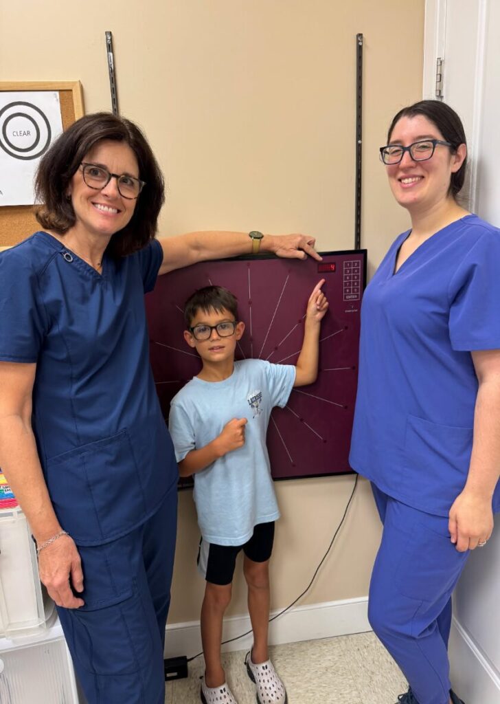 Nicky's VT Completed Pic in front of his favorite activity, the Wayne Saccadic Fixator.